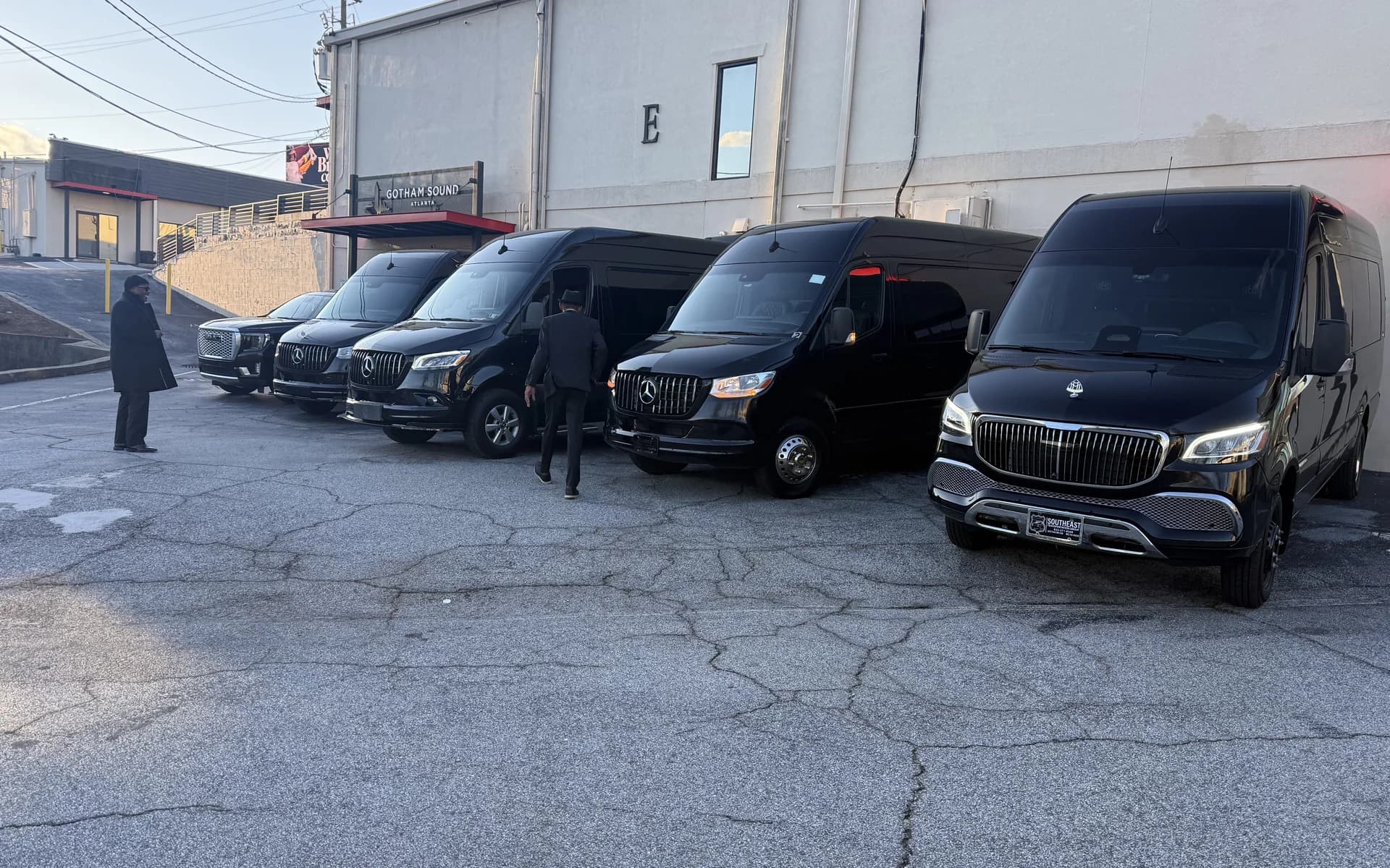 Mercedes Sprinter-style luxury vans lined up for group service